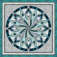 
              Batiks Silver Shores Quilt Kit featuring stunning starburst pattern in teal, silver, and navy shades.
            